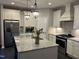 Bright kitchen with white cabinets, stainless steel appliances, and a granite island at 12409 Angel Vale Pl, Durham, NC 27703