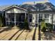 View of the backyard featuring a screened in porch and patio area surrounded by small trees and shrubs at 12409 Angel Vale Pl, Durham, NC 27703