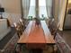 Bright dining room with stylish wooden table and chairs, complete with beautiful rug and natural light at 12409 Angel Vale Pl, Durham, NC 27703