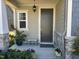 Inviting front door with colorful flowers and stone accents on the exterior of the home at 12409 Angel Vale Pl, Durham, NC 27703