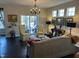 Bright living room with dark hardwood floors, neutral walls and a sliding glass door to the outside at 12409 Angel Vale Pl, Durham, NC 27703