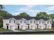 Attractive townhome exterior showcasing a symmetrical design, individual garages, and well-manicured landscaping at 152 Holton St, Smithfield, NC 27577