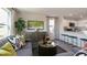 Comfortable living room showcasing stylish furniture, a decorative entertainment center, and an open flow to the kitchen at 152 Holton St, Smithfield, NC 27577