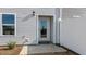 A back door with concrete patio, white siding, a window, and partial view of a white privacy fence at 158 Holton St, Smithfield, NC 27577