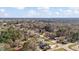 Wide aerial shot displaying residential homes nestled amongst lush trees and foliage at 1721 Raleigh Rd, Henderson, NC 27536