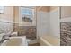 Bathroom offering a modern sink, stone-style wall decor, and a shower/tub combination at 1721 Raleigh Rd, Henderson, NC 27536