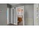 View into the bathroom with a wood vanity and framed mirror at 1721 Raleigh Rd, Henderson, NC 27536