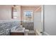 Bathroom featuring a sink with stone-style wall decor and a shower/tub combination at 1721 Raleigh Rd, Henderson, NC 27536