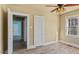 Neutral bedroom offering ample natural light, ceiling fan and wood-look laminate floors at 1721 Raleigh Rd, Henderson, NC 27536