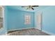 Cozy bedroom with laminate floors, a ceiling fan, and a sunny window at 1721 Raleigh Rd, Henderson, NC 27536