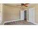 Bright bedroom with neutral walls, wood-look floors, ceiling fan, and two closets at 1721 Raleigh Rd, Henderson, NC 27536