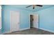 Stylish bedroom featuring laminate floors, bright blue walls, and a ceiling fan at 1721 Raleigh Rd, Henderson, NC 27536