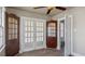 Sitting room with hardwood floors, interior windows, and built-in cabinets at 1721 Raleigh Rd, Henderson, NC 27536