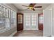 Sitting room with hardwood floors, interior windows, and built-in cabinets at 1721 Raleigh Rd, Henderson, NC 27536