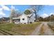 Charming home with a front porch, gravel driveway, and a spacious lawn at 1721 Raleigh Rd, Henderson, NC 27536