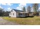 Exterior view of a quaint home with a screened-in porch and well-maintained lawn at 1721 Raleigh Rd, Henderson, NC 27536