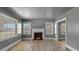 Inviting living room with a brick fireplace and hardwood flooring at 1721 Raleigh Rd, Henderson, NC 27536