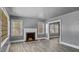 Cozy living room featuring a decorative fireplace, neutral paint, and abundant natural light at 1721 Raleigh Rd, Henderson, NC 27536