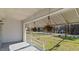 Relaxing covered porch with hanging plants overlooking the grassy front yard at 1721 Raleigh Rd, Henderson, NC 27536