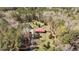 Sprawling property with a red-roofed house, pool, outbuildings, and a long driveway nestled in the woods at 1796 Steel Bridge Rd, Sanford, NC 27330
