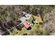 Aerial view of a residence surrounded by trees, featuring a pool and various outbuildings at 1796 Steel Bridge Rd, Sanford, NC 27330