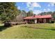 Large backyard with pool, wooded area and red roofed home at 1796 Steel Bridge Rd, Sanford, NC 27330