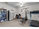 Finished basement with exercise equipment, desk area, and a refrigerator at 1796 Steel Bridge Rd, Sanford, NC 27330