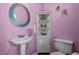 Small bathroom with pink walls, pedestal sink, large mirror, and a corner cabinet at 1796 Steel Bridge Rd, Sanford, NC 27330