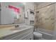 Functional bathroom featuring a vanity, toilet, and combination tub/shower with marble accents at 1796 Steel Bridge Rd, Sanford, NC 27330
