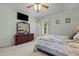 Bright bedroom with a TV, wooden dresser, and pleasant natural light through a window at 1796 Steel Bridge Rd, Sanford, NC 27330