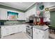 Well-lit kitchen with modern appliances, white cabinetry, and an adjacent dining area at 1796 Steel Bridge Rd, Sanford, NC 27330