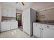 White appliances, cabinets and door, make this an efficient, compact laundry at 1796 Steel Bridge Rd, Sanford, NC 27330