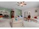 A traditional living room with neutral carpet, fan, furniture, and access to a formal dining room at 1796 Steel Bridge Rd, Sanford, NC 27330