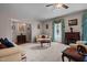 A cozy living room boasts neutral carpet, fireplace and furnishings with a large window for natural light at 1796 Steel Bridge Rd, Sanford, NC 27330