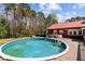 Large above ground pool with wooden sundeck and red-roofed building at 1796 Steel Bridge Rd, Sanford, NC 27330
