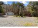 Exterior view of property with multiple storage units in a wooded backyard at 1796 Steel Bridge Rd, Sanford, NC 27330
