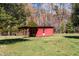 Red building with a covered porch and a door, located in a yard at 1796 Steel Bridge Rd, Sanford, NC 27330