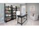Stylish home office featuring built-in shelves, natural light, and comfortable seating at 1802 Brim Dr, Haw River, NC 27258