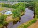 Aerial view of a community pool, parking area, and pond near houses at 199 Pretty Run Branch Lane, Wendell, NC 27591