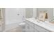 Bright bathroom showcasing dual sinks, white cabinetry, and a combined shower and bathtub at 199 Pretty Run Branch Lane, Wendell, NC 27591