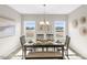 Bright dining room with table, six chairs, bench, and natural light from two windows at 199 Pretty Run Branch Lane, Wendell, NC 27591