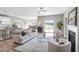 Spacious living room with fireplace, ceiling fan, and seamless access to the kitchen and dining area at 199 Pretty Run Branch Lane, Wendell, NC 27591