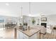 Open concept living area with kitchen island, view of dining area, and living room with fireplace at 199 Pretty Run Branch Lane, Wendell, NC 27591