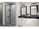 Elegant bathroom with double vanity featuring a marble shower and sleek black framed mirrors at 2007 Trident Maple Ln, Chapel Hill, NC 27517