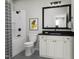 Bright bathroom featuring a vanity with a black countertop, toilet, and shower/tub with black hardware at 2007 Trident Maple Ln, Chapel Hill, NC 27517
