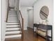 Inviting entryway featuring stylish console table with decor and staircase with wooden rails at 2007 Trident Maple Ln, Chapel Hill, NC 27517