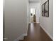 Hallway with hardwood flooring, white trim, and stylish doors leading to sunlit rooms at 2007 Trident Maple Ln, Chapel Hill, NC 27517