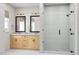 A bathroom with dual sinks, framed mirrors, a neutral color scheme and glass enclosed shower at 2009 Trident Maple Ln, Chapel Hill, NC 27517