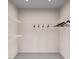 Empty walk-in closet is ready to organize your wardrobe with ample shelving, lighting, and neutral carpet at 2009 Trident Maple Ln, Chapel Hill, NC 27517