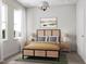 Bright bedroom featuring large windows, neutral tones, and a stylish woven bed frame at 2027 Trident Maple Ln, Chapel Hill, NC 27517